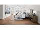 Bright main bedroom with fireplace, wood-look floors, and large windows at 5795 S Pagosa Way, Centennial, CO 80015