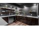 Wet bar with stainless beverage cooler, stylish faucet, wine rack and dark wood cabinetry at 5795 S Pagosa Way, Centennial, CO 80015