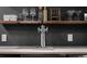 Close-up of wet bar with a stainless beer tap, bar accessories and floating shelves at 5795 S Pagosa Way, Centennial, CO 80015