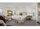Bright bedroom with plush bedding, neutral colors, and ample natural light from multiple windows at 1050 S Monaco Pkwy # 35, Denver, CO 80224