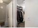 Walk-in closet with built-in shelving, hanging racks, and easy access to adjacent bathroom at 1050 S Monaco Pkwy # 35, Denver, CO 80224