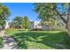 Well-manicured lawn and trees surround a condo complex under a bright blue sky at 1050 S Monaco Pkwy # 35, Denver, CO 80224