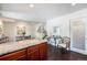 Open kitchen with granite countertops, dark wood cabinets, and adjacent dining area with modern art at 1050 S Monaco Pkwy # 35, Denver, CO 80224