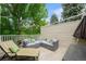 Relaxing patio features cushioned seating, a chaise lounge, and lush greenery at 1050 S Monaco Pkwy # 35, Denver, CO 80224