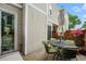 Cozy outdoor patio with a round table, chairs, and blossoming flowers at 1050 S Monaco Pkwy # 35, Denver, CO 80224