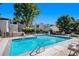 Sparkling community pool surrounded by lounge chairs and lush landscaping at 1050 S Monaco Pkwy # 35, Denver, CO 80224
