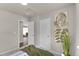 Bright bedroom showcasing neutral walls, tasteful artwork and a glimpse into an adjacent room at 46550 Avery Ln, Bennett, CO 80102