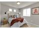 Cozy bedroom with layered textures, bright natural light, and accent furniture at 46550 Avery Ln, Bennett, CO 80102