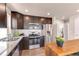 Modern kitchen features stainless steel appliances, granite countertops, and wooden cabinets at 46550 Avery Ln, Bennett, CO 80102