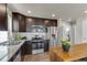 Modern kitchen features stainless steel appliances, granite countertops, and wooden cabinets at 46550 Avery Ln, Bennett, CO 80102