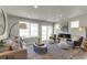Spacious living room with plush carpet, fireplace, large windows providing beautiful natural light and comfortable furniture at 46550 Avery Ln, Bennett, CO 80102
