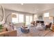 Bright and spacious living room with ample seating, a fireplace, and large windows with views at 46550 Avery Ln, Bennett, CO 80102