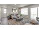 Cozy living room with a large mirror, a sliding glass door, and a comfortable couch at 46550 Avery Ln, Bennett, CO 80102