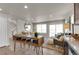 Bright living room with large windows, a fireplace, and an island bar with seating at 46550 Avery Ln, Bennett, CO 80102