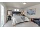 Modern bedroom featuring a padded headboard, two side tables and lamps, an accent rug, and bright natural light at 46550 Avery Ln, Bennett, CO 80102