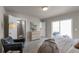 Bright bedroom with light gray carpet, a walk-in shower, access to a deck and comfortable sitting area at 46550 Avery Ln, Bennett, CO 80102