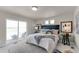 Bright main bedroom featuring a walk out balcony, and modern furniture at 46550 Avery Ln, Bennett, CO 80102