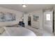 Bright bedroom with light gray carpet, en-suite bathroom, walk-in shower, and comfortable sitting area at 46550 Avery Ln, Bennett, CO 80102