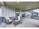 Comfortable back porch with wicker furniture and sliding glass door access to the main house at 2967 S Quaker St, Morrison, CO 80465