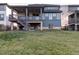 Spacious backyard with lush green lawn, a deck, and outdoor stairs offers relaxation and entertainment at 2967 S Quaker St, Morrison, CO 80465