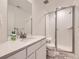 Modern bathroom featuring a sleek vanity, frameless glass shower, and neutral color palette at 2967 S Quaker St, Morrison, CO 80465