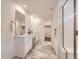 This bathroom features marble floors, glass enclosed shower, and a double sink at 2967 S Quaker St, Morrison, CO 80465