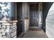 Front entryway with stone accents, dark door, and modern exterior design at 2967 S Quaker St, Morrison, CO 80465