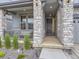 Charming front porch with stone columns, decorative lighting, and a cozy entrance at 2967 S Quaker St, Morrison, CO 80465