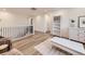 Bright hallway features hardwood floors, white walls, and white shelving unit perfect for storage and decor at 2967 S Quaker St, Morrison, CO 80465