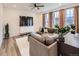 Cozy living room with a sectional sofa, decorative plants, and large windows at 2967 S Quaker St, Morrison, CO 80465