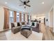 Spacious living room with a large sectional sofa, lots of windows, and ceiling fan at 2967 S Quaker St, Morrison, CO 80465