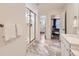 The ensuite bathroom features marble floors, glass enclosed shower, and a double sink at 2967 S Quaker St, Morrison, CO 80465
