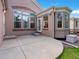 Backyard view of a concrete patio, a fenced yard, a lawn, and the home's exterior at 6700 W Dorado Dr # 47, Littleton, CO 80123
