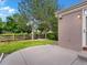 A fenced backyard featuring a concrete patio, grass, and trees at 6700 W Dorado Dr # 47, Littleton, CO 80123