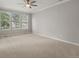 Spacious bedroom features three large windows, providing ample natural light and a bright, inviting atmosphere at 6700 W Dorado Dr # 47, Littleton, CO 80123