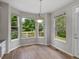 Bright breakfast nook featuring hardwood floors, a pendant light, and large windows overlooking the backyard at 6700 W Dorado Dr # 47, Littleton, CO 80123