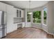 Bright breakfast nook with white cabinets, built-in desk and a view of the backyard at 6700 W Dorado Dr # 47, Littleton, CO 80123