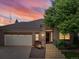 Inviting home featuring a two-car garage, concrete steps leading to the front door, and mature landscaping at 6700 W Dorado Dr # 47, Littleton, CO 80123