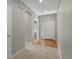 Entry hallway featuring carpet and wood floors, light gray walls, and white trim with a glass block window at 6700 W Dorado Dr # 47, Littleton, CO 80123