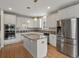 Modern kitchen featuring white cabinets, an island, and stainless steel appliances at 6700 W Dorado Dr # 47, Littleton, CO 80123