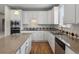 Updated kitchen with white cabinets, granite countertops, and stainless steel appliances at 6700 W Dorado Dr # 47, Littleton, CO 80123