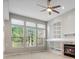 Bright living room with a fireplace, custom built-ins, and large windows, offering a cozy and stylish gathering space at 6700 W Dorado Dr # 47, Littleton, CO 80123