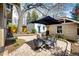 Brick patio with shade umbrella and dining area, surrounded by a landscaped backyard at 780 N Franklin St, Denver, CO 80218