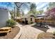 Brick patio with dining table, surrounded by greenery and charming backyard elements at 780 N Franklin St, Denver, CO 80218
