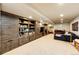 Spacious finished basement with built-in shelving, plush seating, and neutral carpet at 780 N Franklin St, Denver, CO 80218