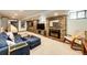 Cozy basement with stone fireplace, plush seating, built-in shelving, and natural light at 780 N Franklin St, Denver, CO 80218