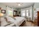 A serene bedroom with a large window, natural light, hardwood floors and neutral tones at 780 N Franklin St, Denver, CO 80218