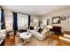 Sun-drenched living room featuring hardwood floors, a large sectional sofa, and classic details at 780 N Franklin St, Denver, CO 80218