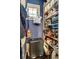 A walk-in pantry featuring shelving stocked with various food items, cleaning supplies and dark hardwood floors at 780 N Franklin St, Denver, CO 80218
