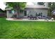 Spacious backyard featuring a patio with outdoor furniture and a lush lawn at 1936 S Poplar St, Denver, CO 80224